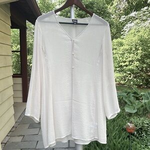 Sheer long sleeve tunic top. Tailored with delicate details. Buttons in front.